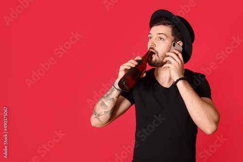 Stylish young man with bott...