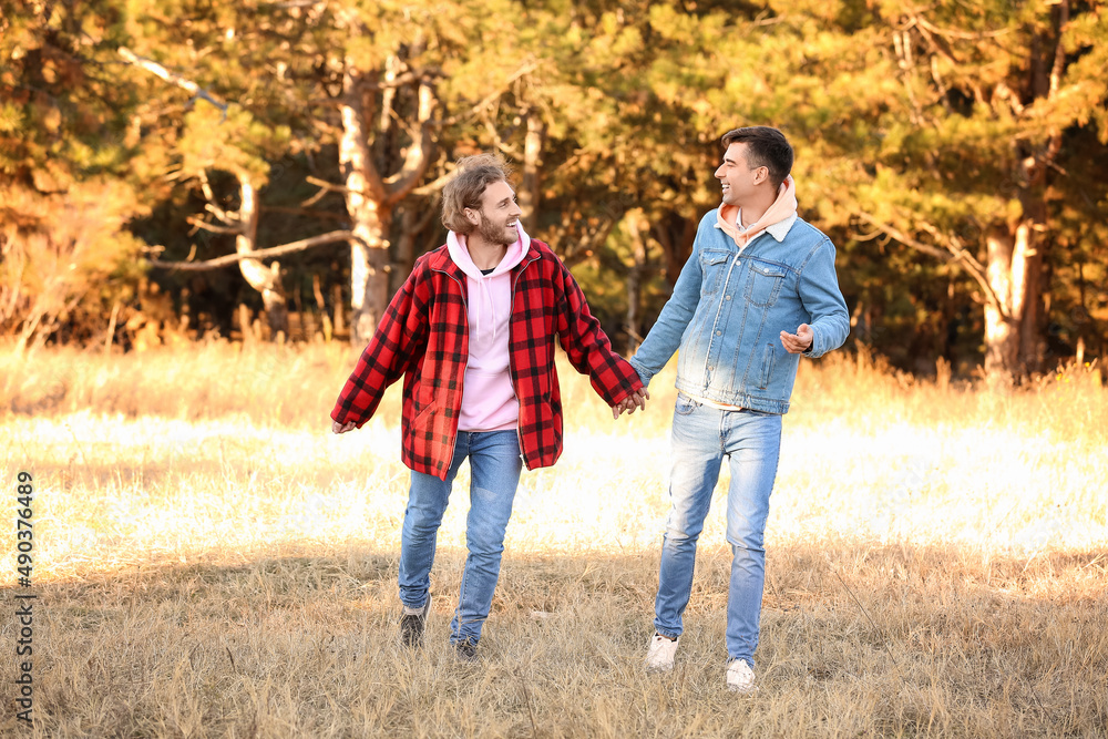 Fototapeta premium Happy gay couple walking outdoors on autumn day