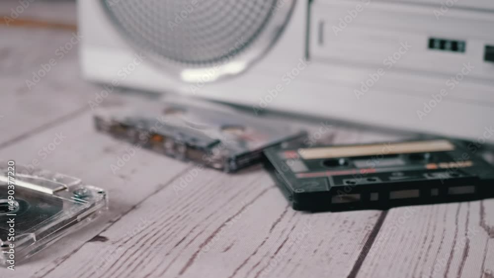 Female Hands Throwing a Lots Old Audio Cassettes on Table. Trash. A