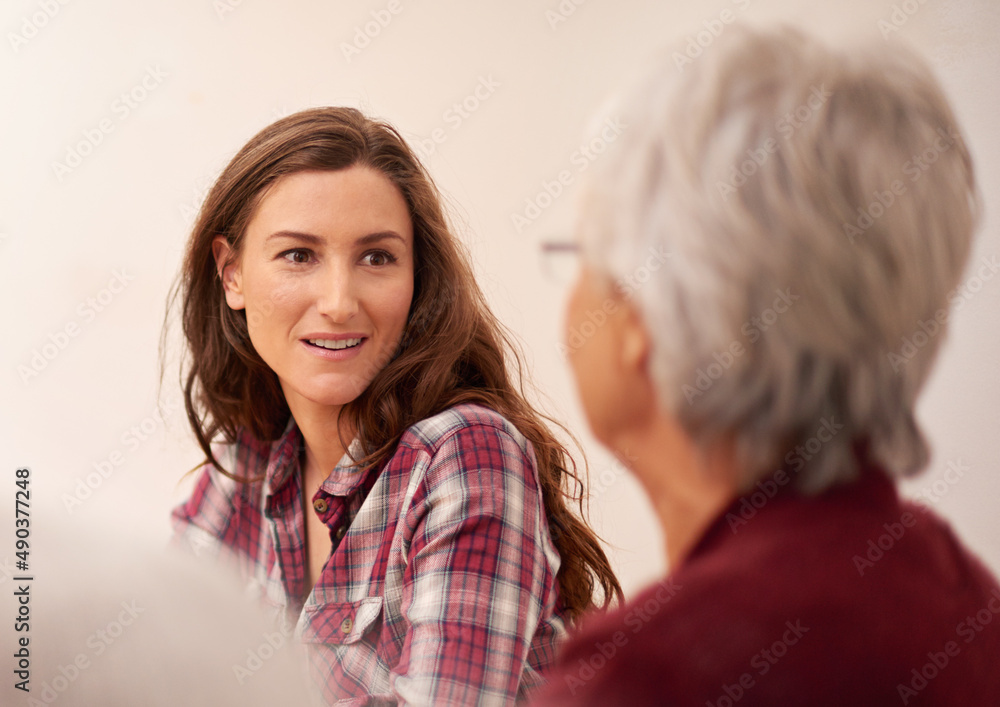 She admires her mother. Shot of an attractive woman bonding with her senior mother at home. She admires her mother. Shot of an attractive woman bonding with her senior mother at home.