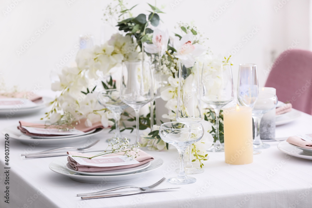 Stylish table setting with wedding invitations and gypsophila flowers Stylish table setting with wedding invitations and gypsophila flowers