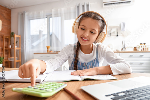 Little girl in headphones s...