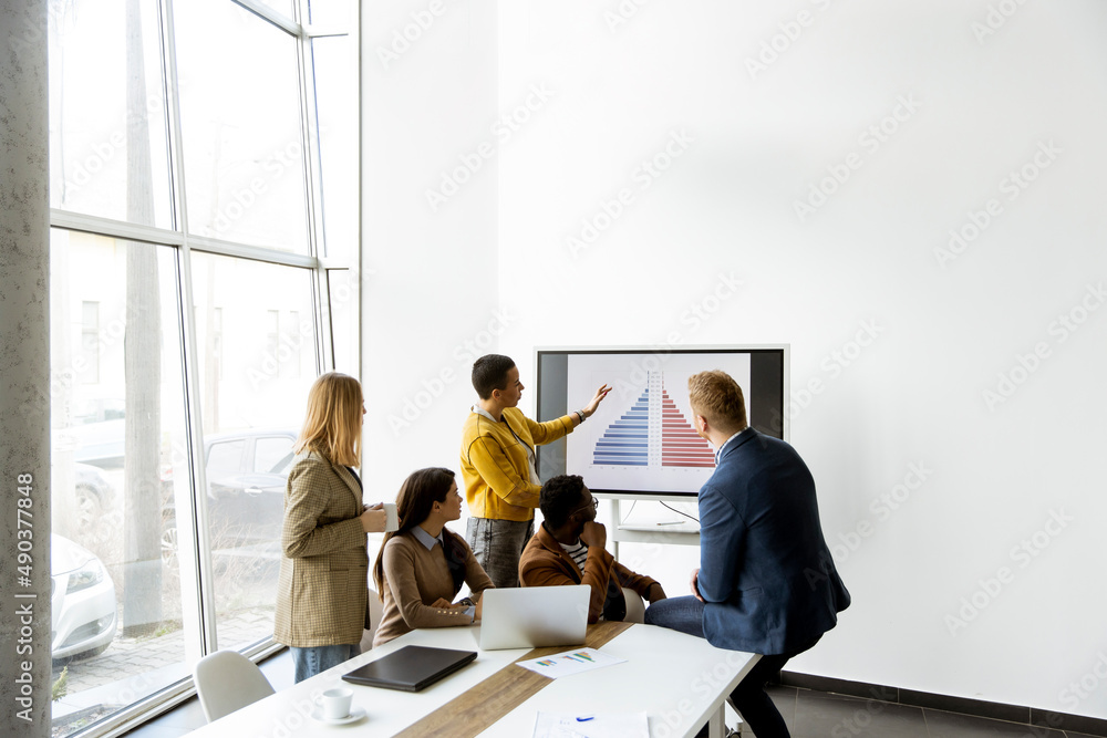 Group of multiethnic business people working together and preparing new project on a meeting in office Group of multiethnic business people working together and preparing new project on a meeting in office