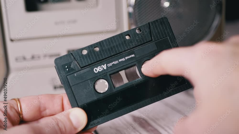 Female Rewinds a Tape with Finger on Old Vintage Audio