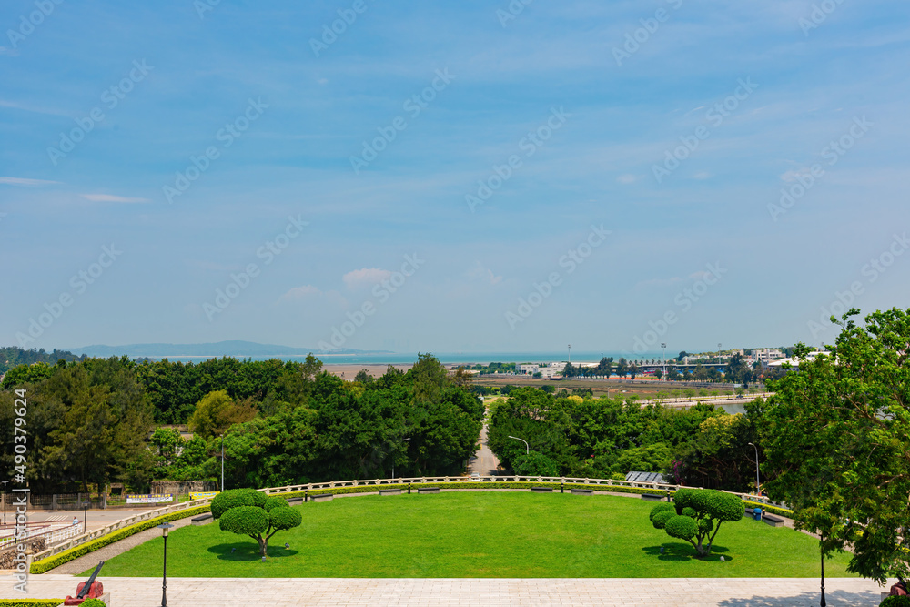Sunny view of the garden of Juguang Tower and cityscape