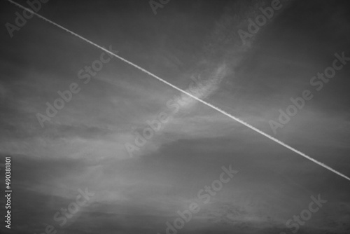 sky with clouds and plane trail