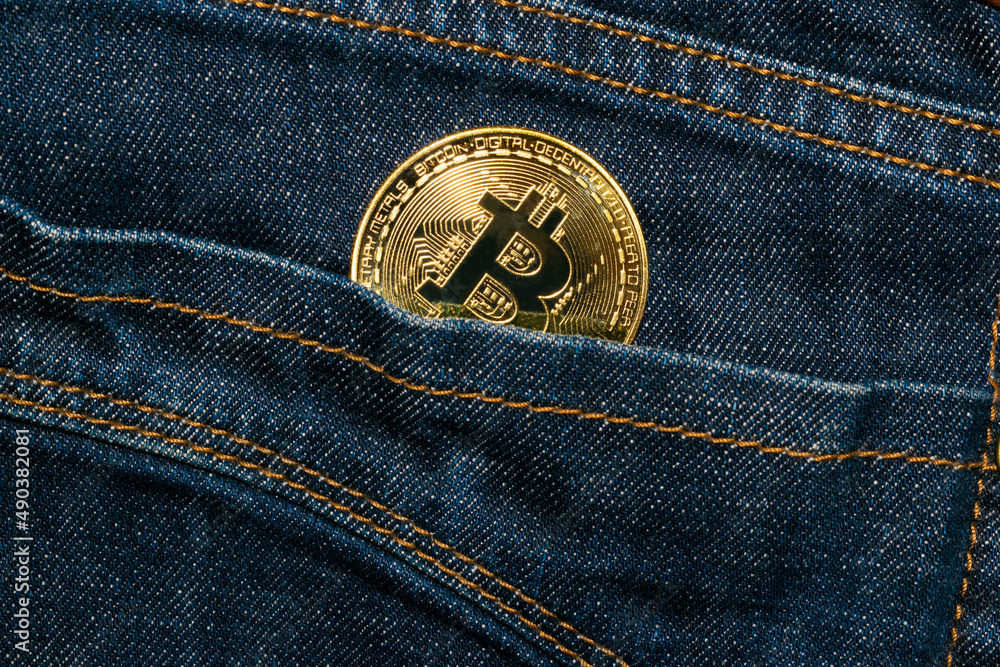 Bitcoin gold coin in jeans pocket investment concept Bitcoin gold coin in jeans pocket investment concept