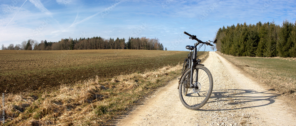 Fototapeta premium Discover nature with the trekking bike away from the paved roads on country lanes.