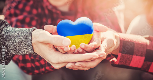 Hands holding a heart in Ukrainian colours photo
