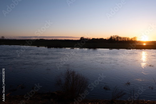 clear sky  golden sunset  winding river  purple clouds  spring evening near Lielupe river Latvia