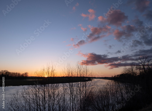 clear sky, golden sunset, winding river, purple clouds, spring evening near Lielupe river Latvia photo