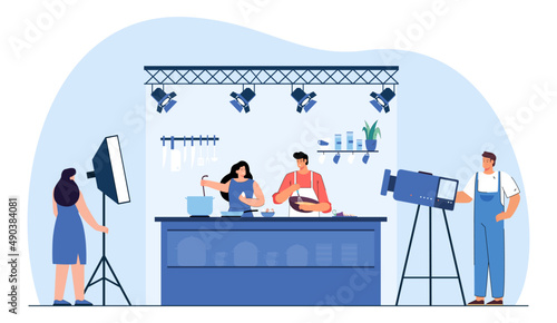 Cameraman shooting cooking TV show flat vector illustration. Popular chef and woman preparing food in studio, mixing ingredients, talking, explaining audience how to cook. Television concept