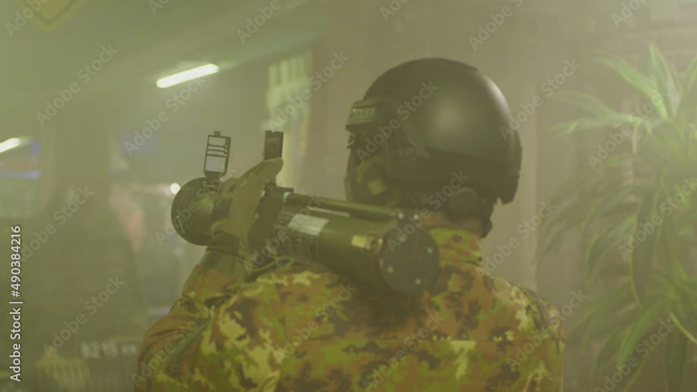 Private Military Company operator shoots from an RPG rocket launcher . Soldier with antitank grenade launcher . R. P. G. shooter shooting . Shot on ARRI movie camera in Slow Motion . Private Military Company operator shoots from an RPG rocket launcher . Soldier with antitank grenade launcher . R. P. G. shooter shooting . Shot on ARRI movie camera in Slow Motion .