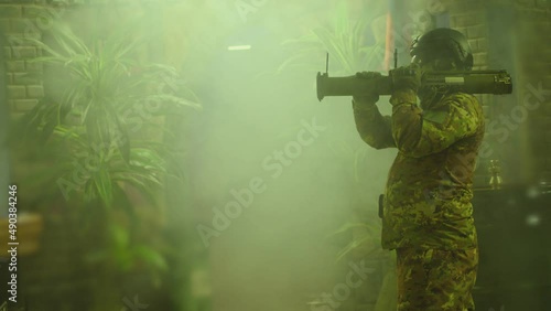 Private Military Company operator shoots from an RPG rocket launcher . Soldier with antitank grenade launcher . R. P. G. shooter shooting . Shot on ARRI movie camera in Slow Motion .