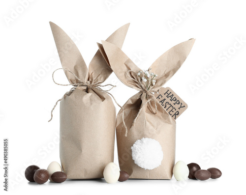 Easter bunny gift bags and chocolate eggs isolated on white background