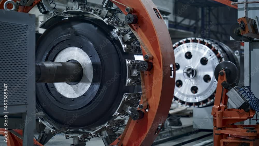 Robotic tyre plant machine at technological manufacture with background worker Robotic tyre plant machine at technological manufacture with background worker