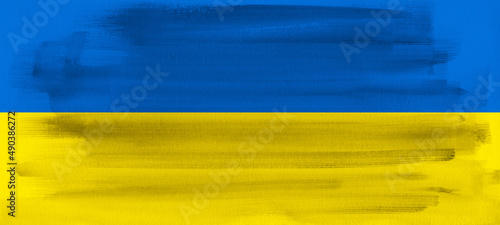 Abstract patriotic brushstroke paint brush splash in the colors of the flag of Ukraine, isolated on aquarelle paper background