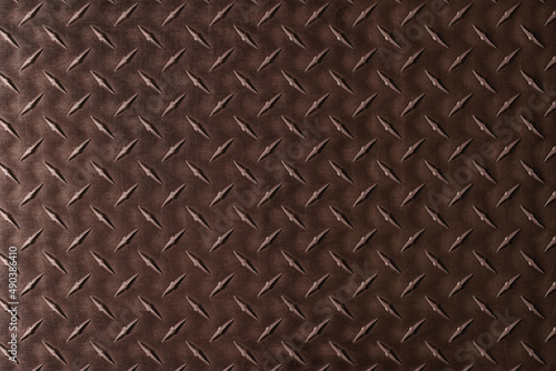 Dark metal texture of steel plate. brown iron background with diamond pattern.