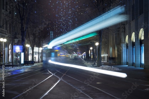 City Tram at Night with Light Trails in Long Exposure in Bahnhofstrasse in Zurich, Switzerland. photo