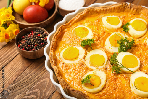 Tasty Easter tart with eggs on wooden background, closeup
