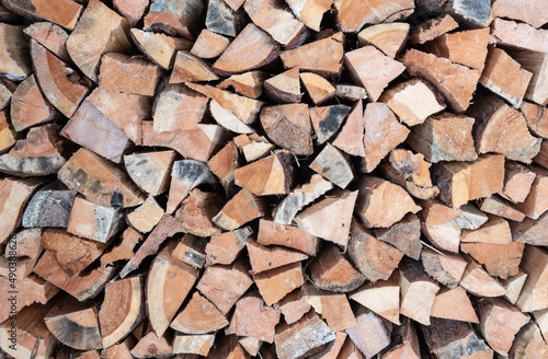 Stack of firewood. Chopped wood logs background.