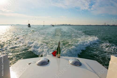 Elegant Motorboat with Italian Flag 21 on Mediterranean Sea in a Sunny Day in Venice, Veneto in Italy.  photo