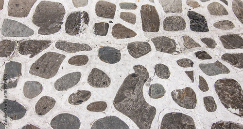 Fototapeta Naklejka Na Ścianę i Meble -  Stone paved street background in Greece. 