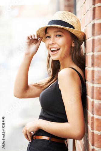 Happy about summertime. Playful portrait of a gorgeous young woman wearing a hat.