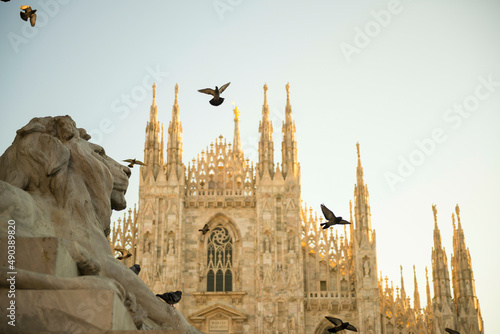 Milan Cathedral and Lion Statue with Sunlight in Lombardy, Italy. photo