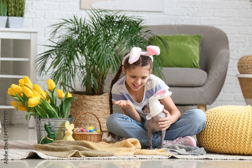 Little girl with Sphynx cat...