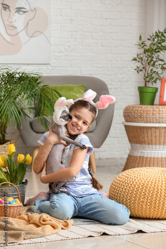 Little girl with Sphynx cat...