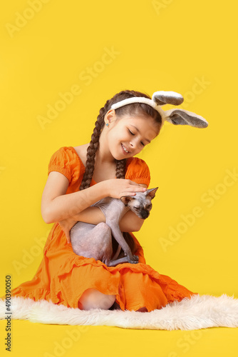 Little girl in bunny ears w...