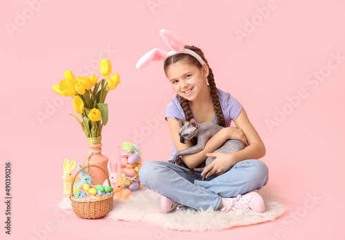 Little girl with Sphynx cat...