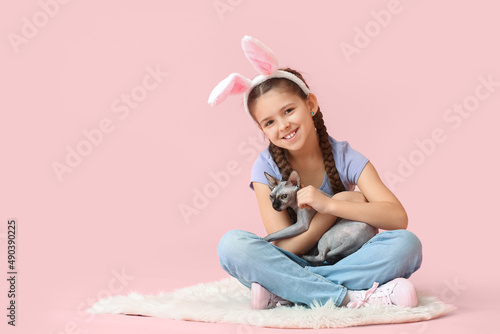 Little girl in bunny ears w...