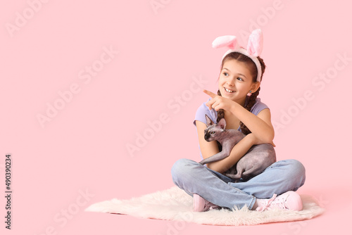 Little girl in bunny ears w...