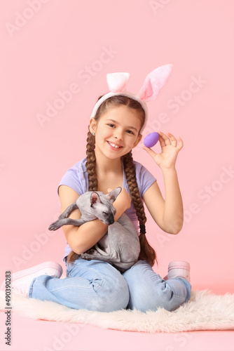 Little girl with Sphynx cat...