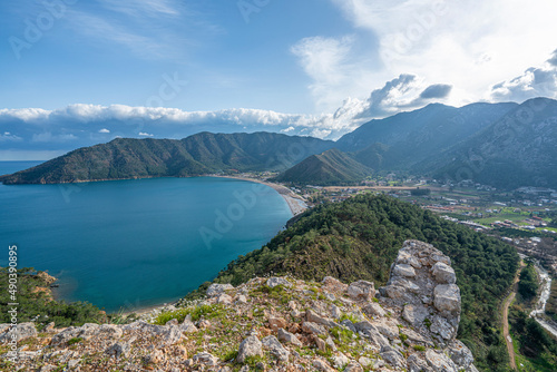The Scenic view of Bay of Adrasan from the Adrasan Castle, naturally protected area, surrounded by a national park with pine forests, Taurus Mountains, blue water lagoons and sandy beaches.