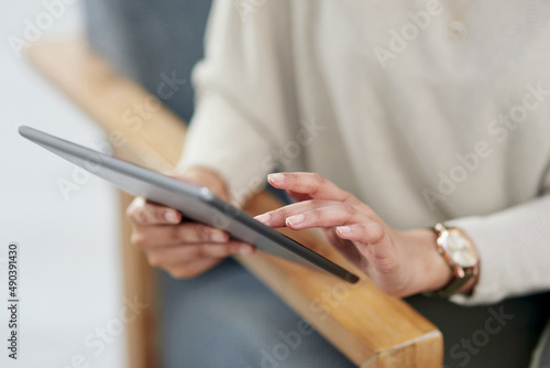 Ditch a heavy laptop for a slim digital tablet instead. Closeup shot of an unrecognisable businesswoman using a digital tablet in an office.
