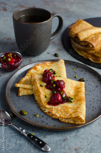 creaps with cherry confiture and pistachios photo