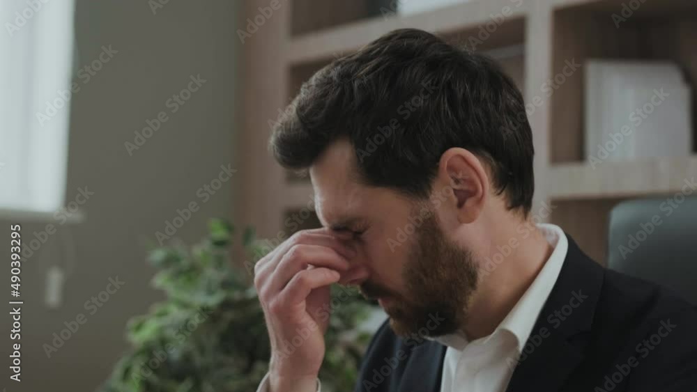 Close up of an executive or an office worker closing his eyes from the tiredness. Close up of an executive or an office worker closing his eyes from the tiredness.