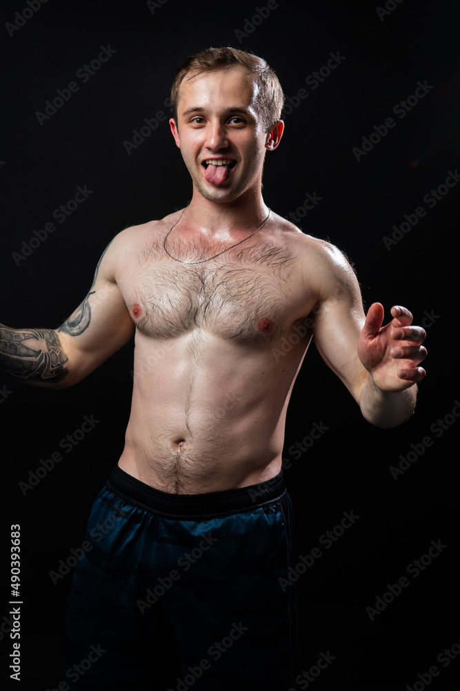 Obraz premium Man on black background keeps dumbbells pumped up in fitness bodybuilding biceps torso, training workout athletic person Young skin human fit