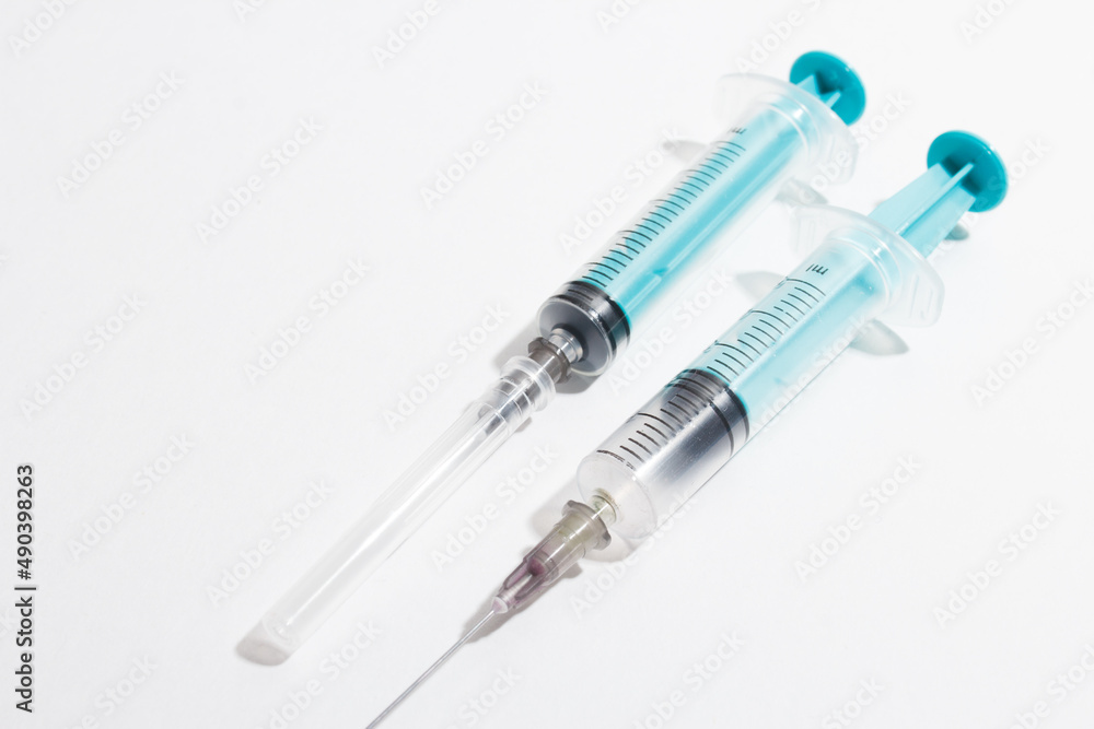 Medical syringe on a white background. A syringe for injection. The concept of health and beauty Medical syringe on a white background. A syringe for injection. The concept of health and beauty
