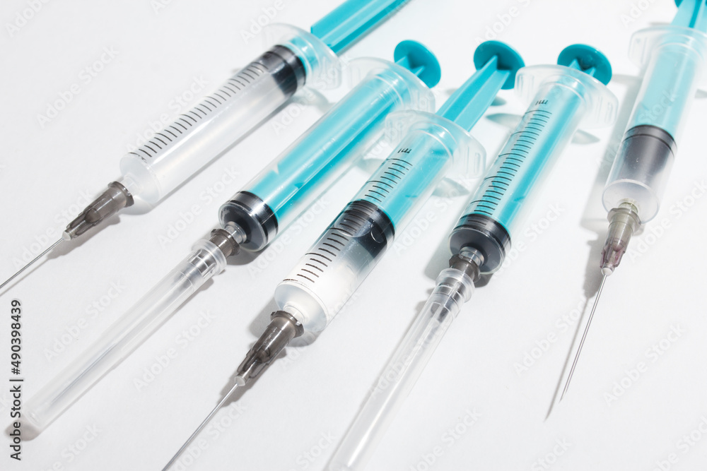 Medical syringe on a white background. A syringe for injection. The concept of health and beauty Medical syringe on a white background. A syringe for injection. The concept of health and beauty