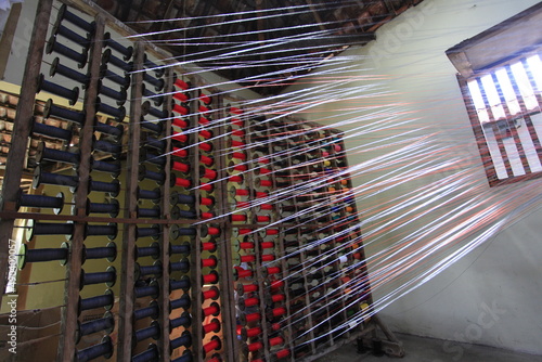 Colorful string used for traditional lurik weaving in a garment factory producing lurik fabric. 