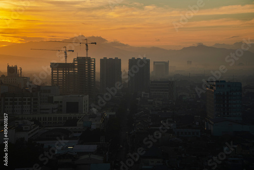 Foggy city view in the morning with beautiful sun shining in Bandung, Indonesia