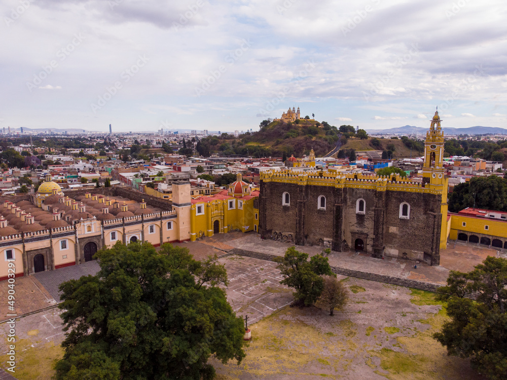 Fototapeta premium Aerial Drone Shot of San Gabriel Archangel Cathedral at cloudy day in Cholula, Puebla, Mexico