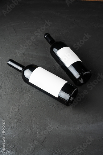 Bottle of Red Wine on a black background. Wine Bottle with Blank Label Mockup