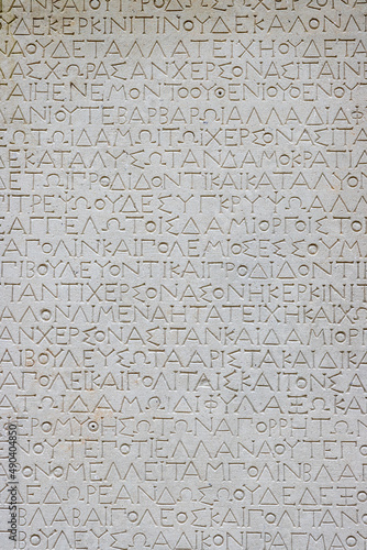 A fragment of a text in ancient Greek, minted on a marble slab. A copy of the oath of citizens of Chersonesus III c. BC e. Ancient archaeological epigraphic monument. Chersonesus, Sevastopol, Crimea.