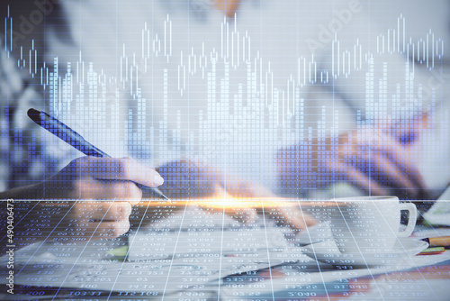 Double exposure of forex graph drawing over people taking notes background. Concept of financial analysis