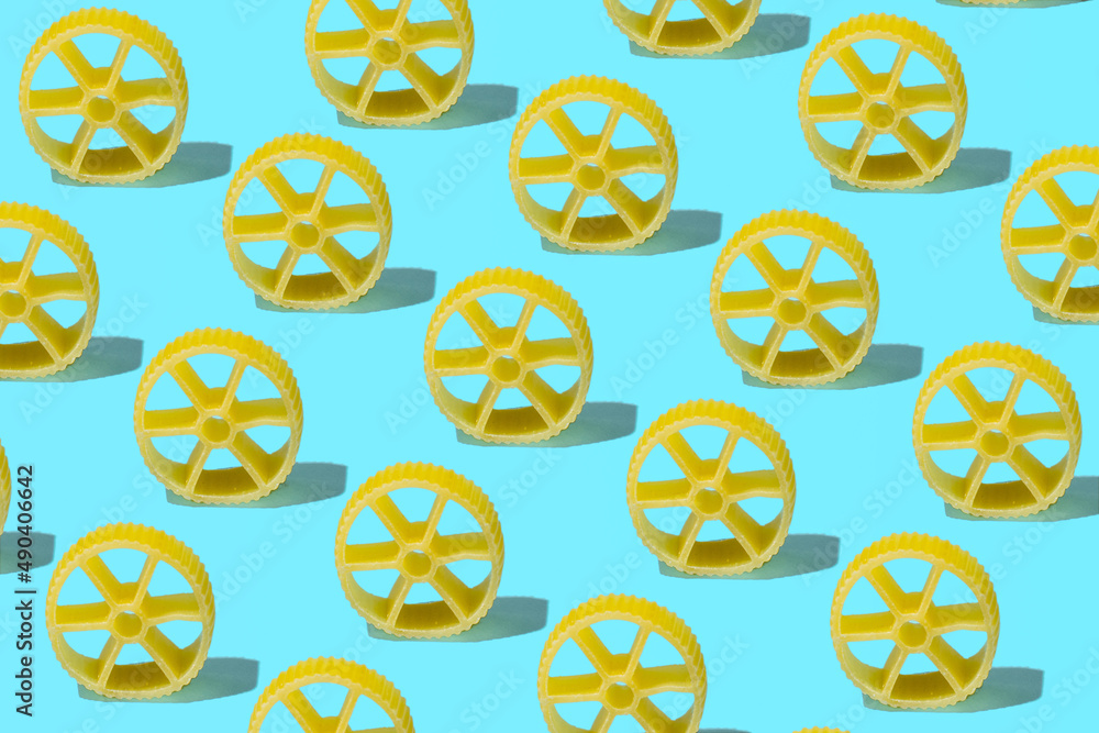 Italian pasta creative pattern against pastel blue background. Wagon wheels shape. 